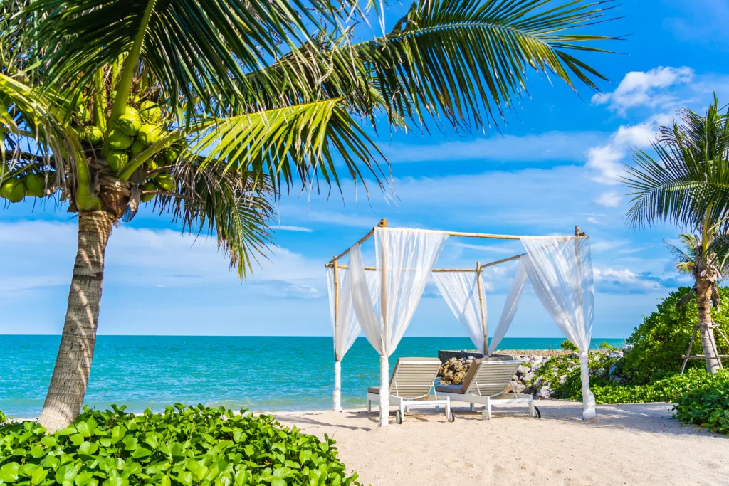 Beautiful umbrella and chair around beach sea ocean with blue sky for travel vacation