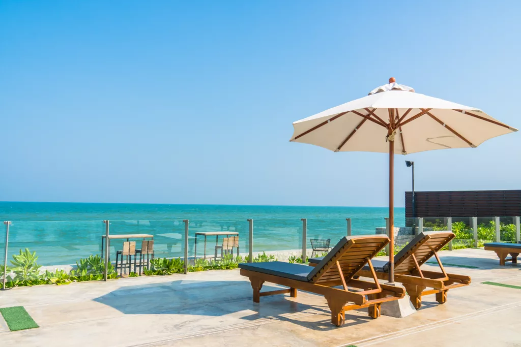 Beautiful umbrella and chair around swimming pool in hotel and resort - vacation concept - Bali Dive Resort