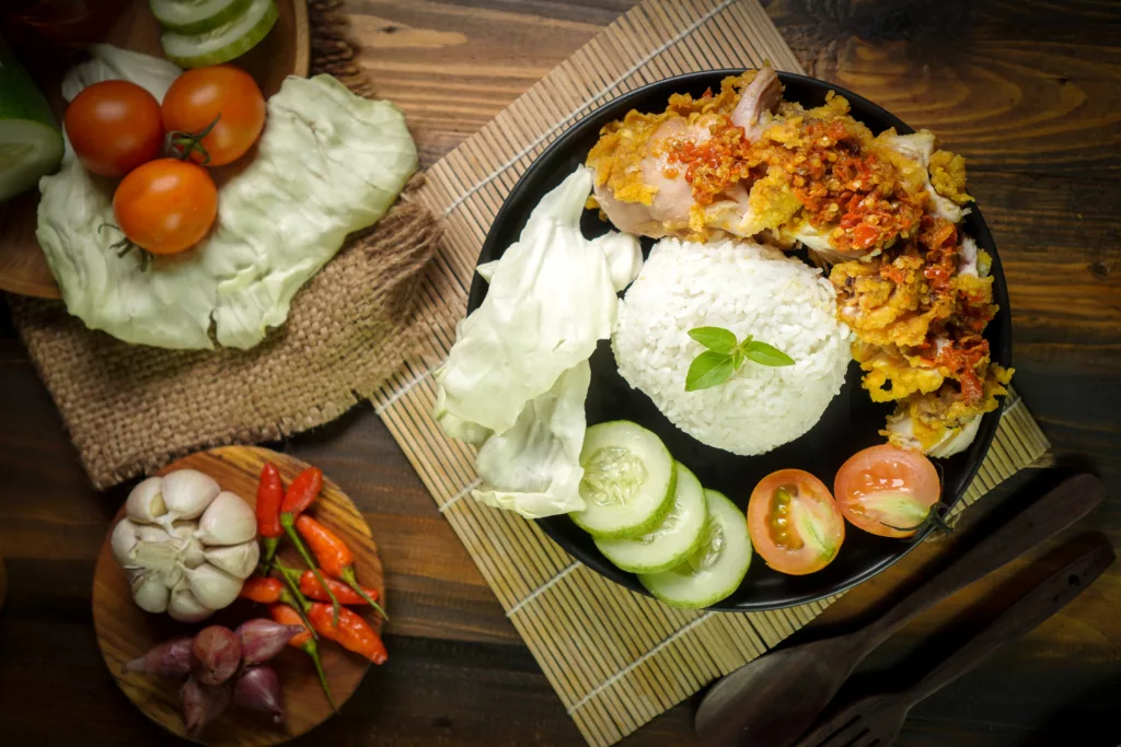 fried chicken crushed plate table mixed with hot spicy sambal - Bali Dive Resort