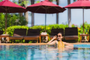 Portrait beautiful young asian woman leisure relax smile and happy around swimming pool in hotel resort for holiday vacation trip - Bali Dive Resort