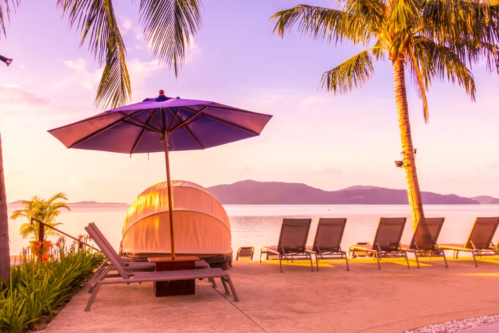 Beautiful outdoor view with umbrella and chair around swimming pool in luxury hotel and resort at sunrise time for travel and vacation - Bali dive resort