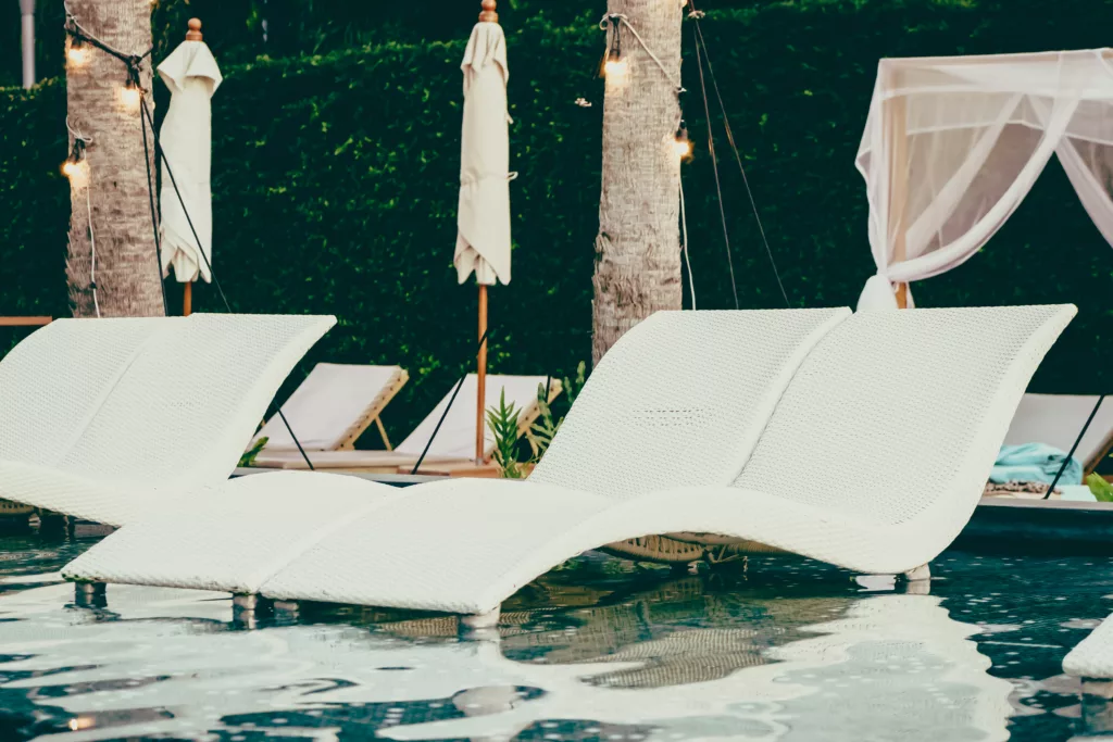 Beautiful luxury pool Chair in hotel swimming pool at Twilight times - Vintage filter Processing - Bali Dive Resort